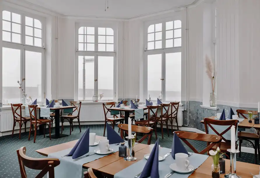 Ein Zimmer im Hotel Borkum Hotel Roulette bietet einen angenehmen Ambiente mit weißem und blauem Dekor. Die Tische sind