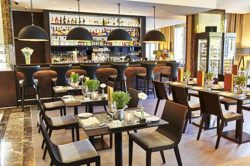Ein elegantes Restaurant- und Barbereich im Hotel Steigenberger in Köln 2. Die Atmosphäre ist warm und einladend mit dunklen