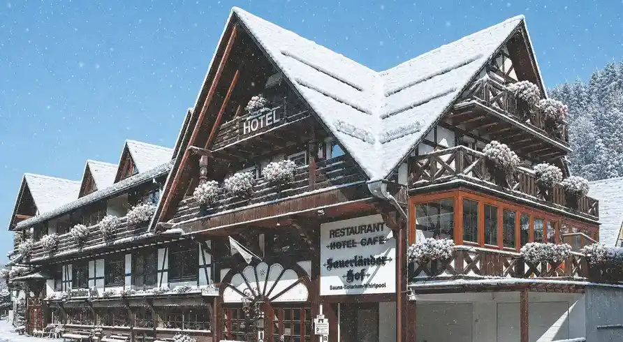Das Hotel Sauerländer Hof in Willingen, das im Winter mit Schnee bedeckt ist. Die einladende Architektur mit traditionellen