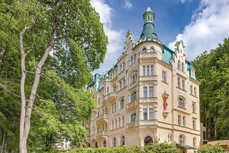 Ein historisches Kurhotel in Marienbad mit einem charmanten Aussehen und einem grünen Umfeld. Das Ensana Svoboda Hotel